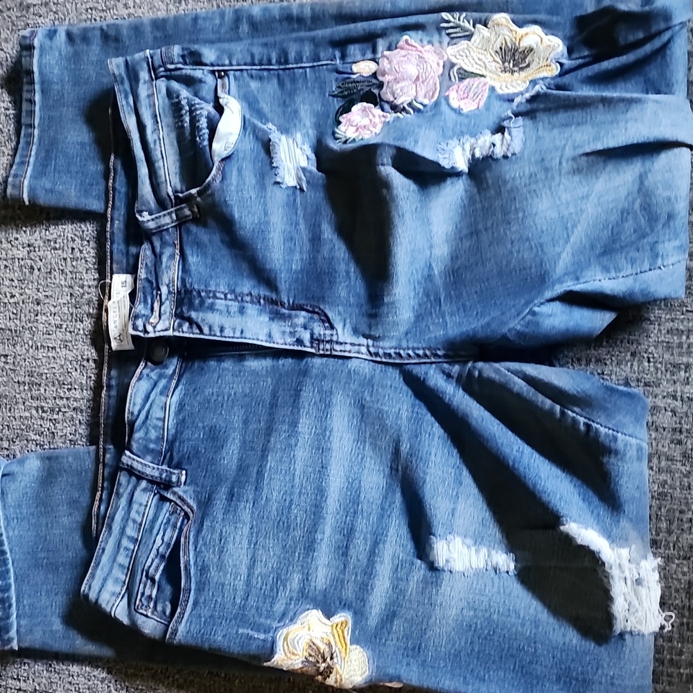 Angel Kiss embroidered and distressed jeans.